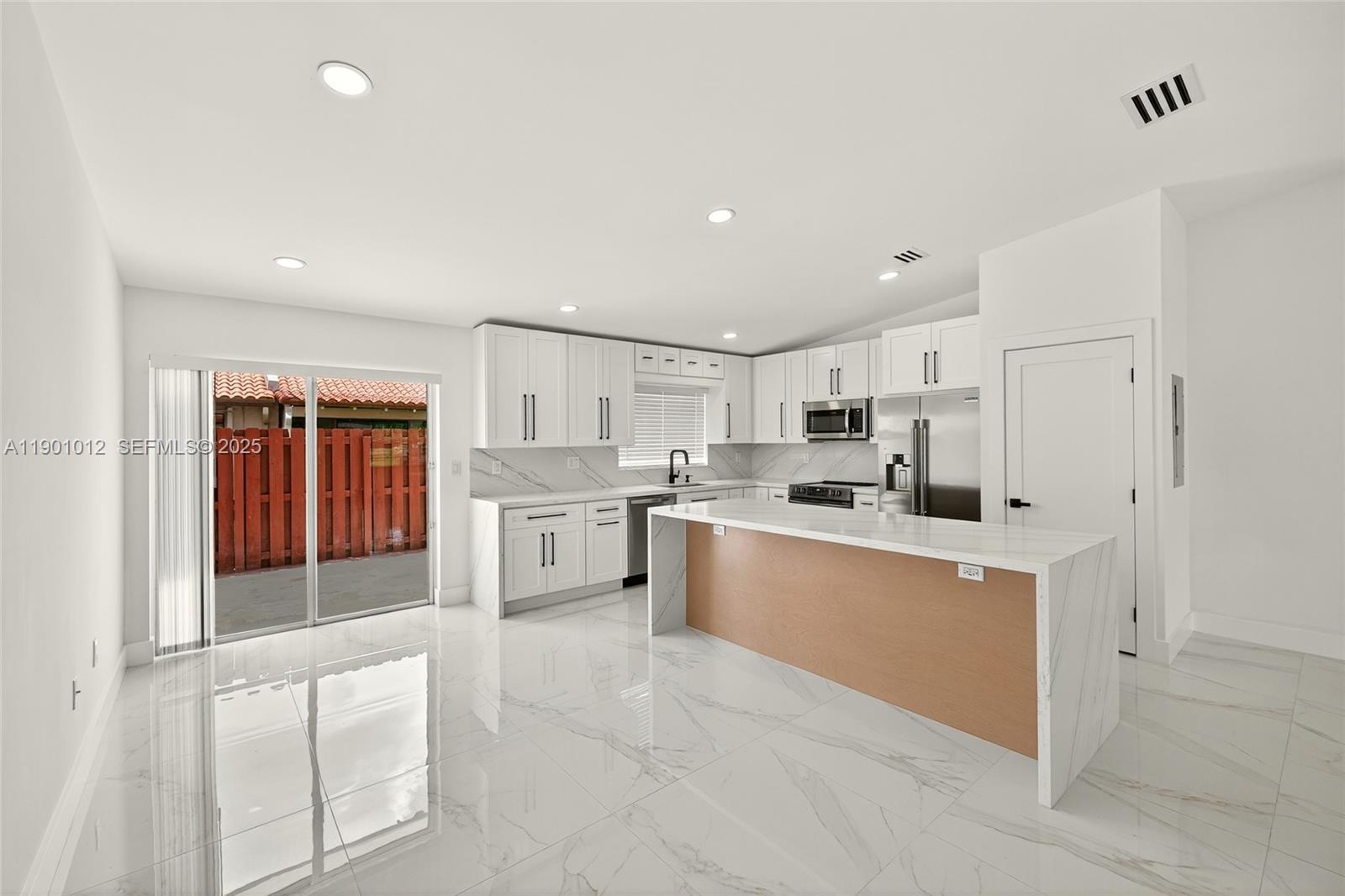 5913 Southwest 112th Terrace Cooper City, FL 33330 - Photo 5 of 31 a kitchen with white cabinets and white appliances