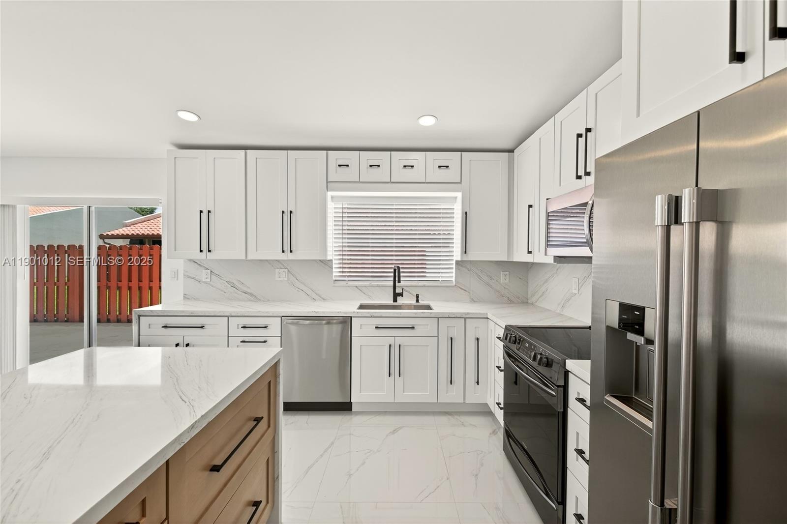 5913 Southwest 112th Terrace Cooper City, FL 33330 - Photo 6 of 31 a kitchen with a sink stove and refrigerator
