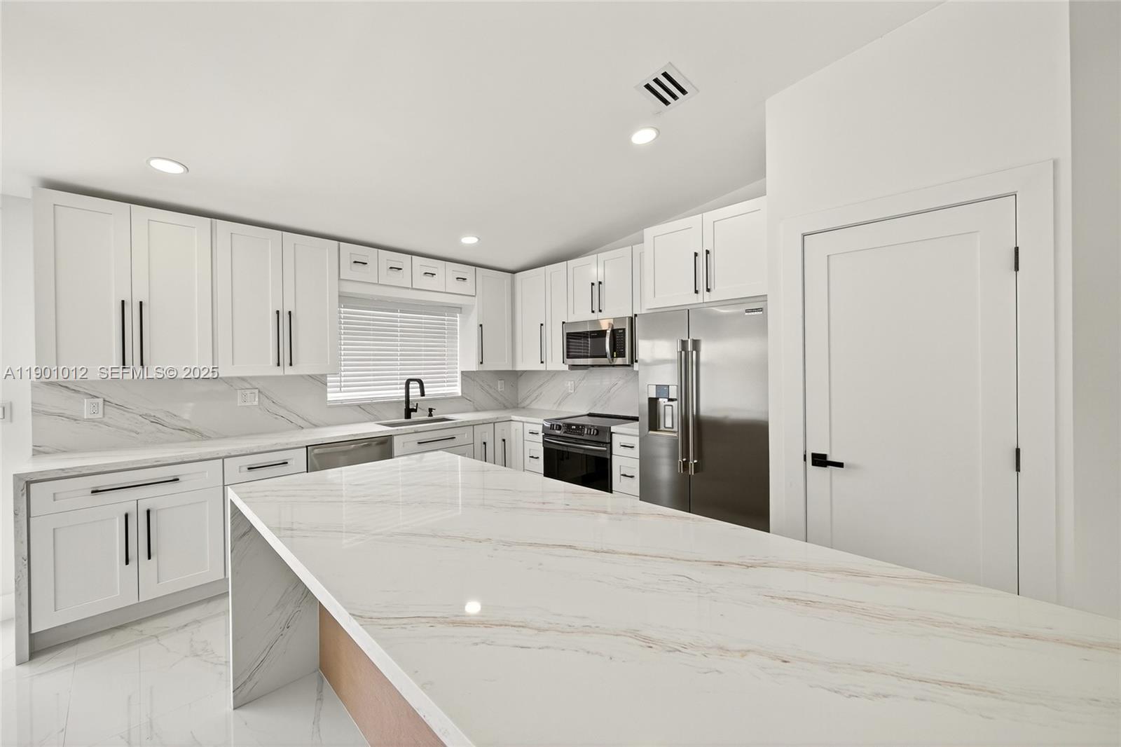 5913 Southwest 112th Terrace Cooper City, FL 33330 - Photo 7 of 31 a kitchen with stainless steel appliances a refrigerator sink and cabinets