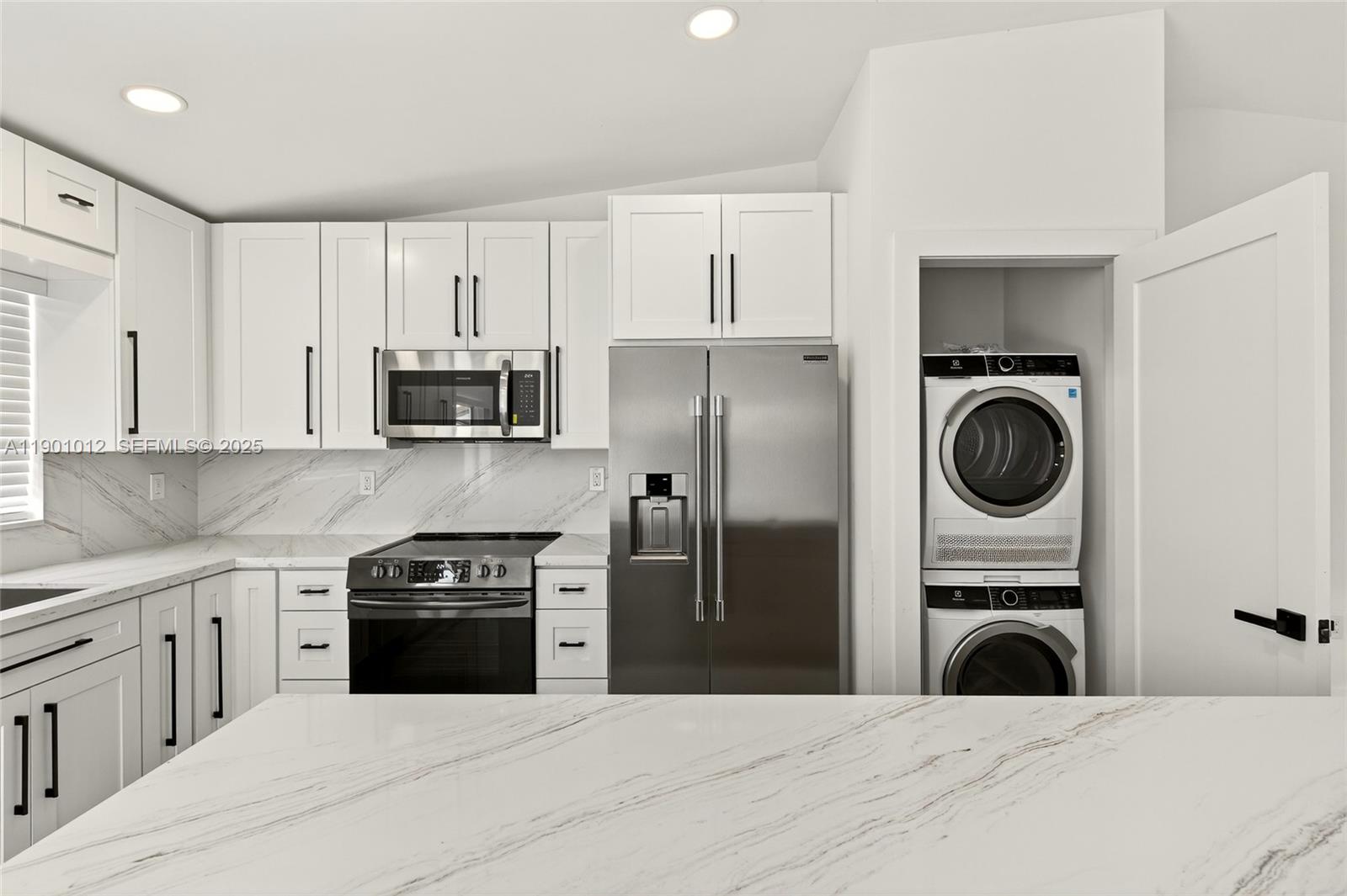 5913 Southwest 112th Terrace Cooper City, FL 33330 - Photo 8 of 31 a kitchen with white cabinets and stainless steel appliances
