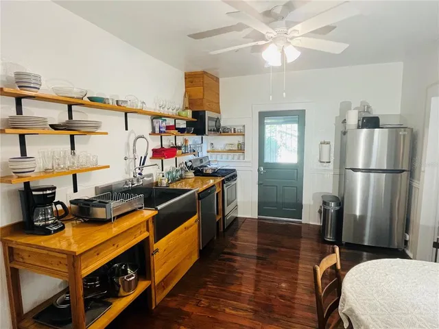 a kitchen with stainless steel appliances a stove refrigerator and cabinets