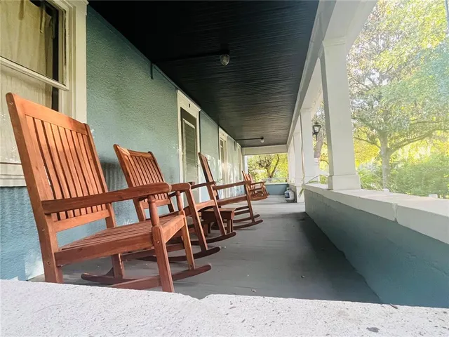 a view of an chairs and table in the balcony