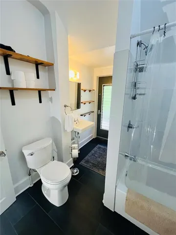 a bathroom with a sink toilet and shower