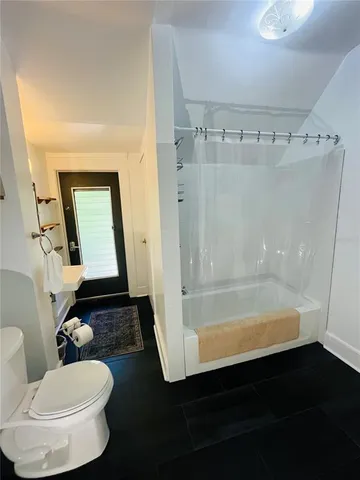a bathroom with a bathtub and a shower