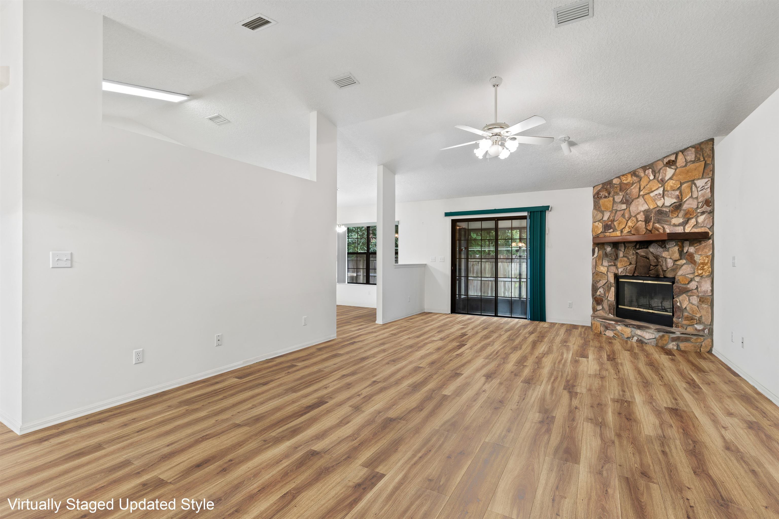 215 Cypress Road St. Augustine, FL 32086 - Photo 3 of 30 a view of empty room with wooden floor and fan