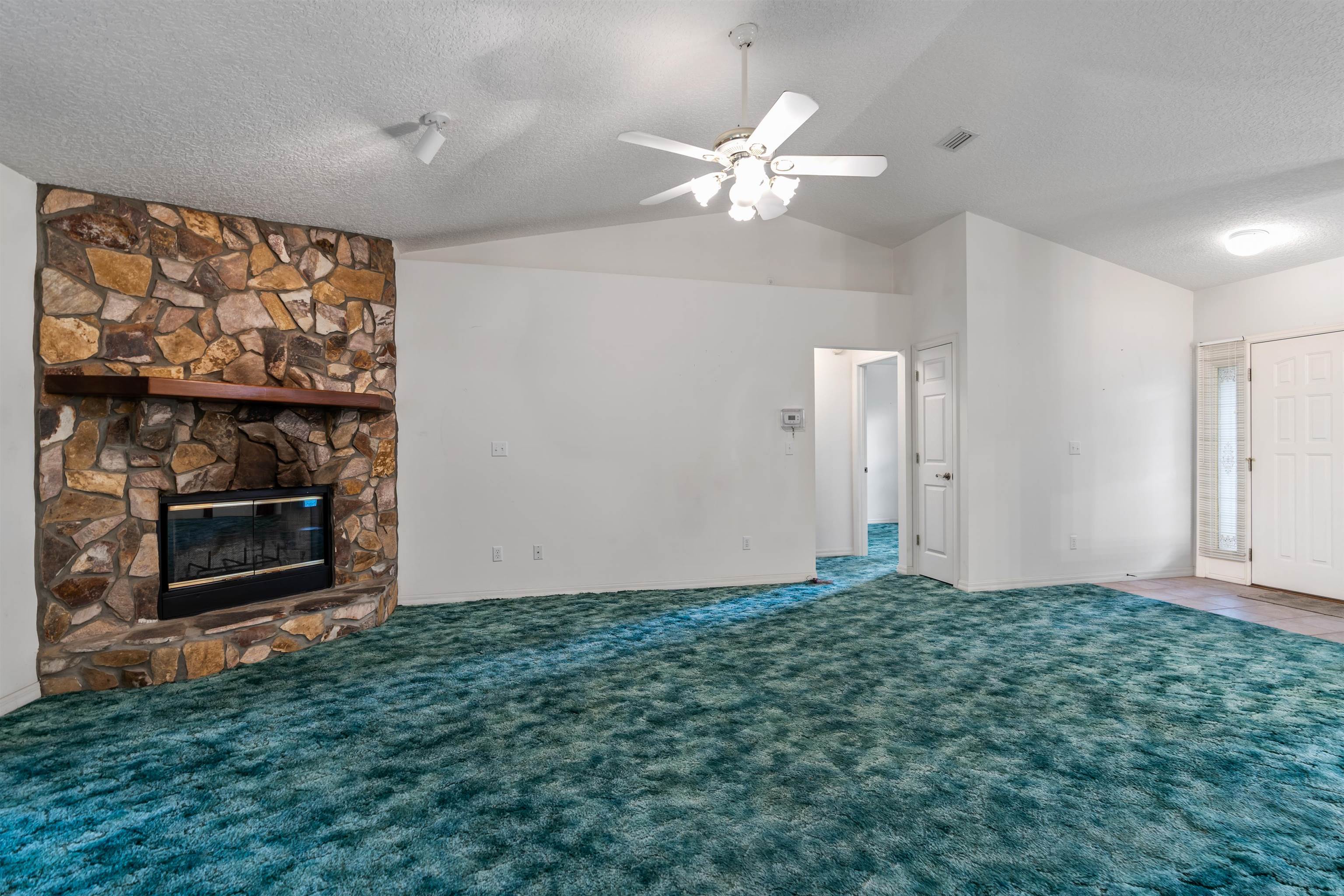 215 Cypress Road St. Augustine, FL 32086 - Photo 5 of 30 wooden floor in an empty room with a fireplace