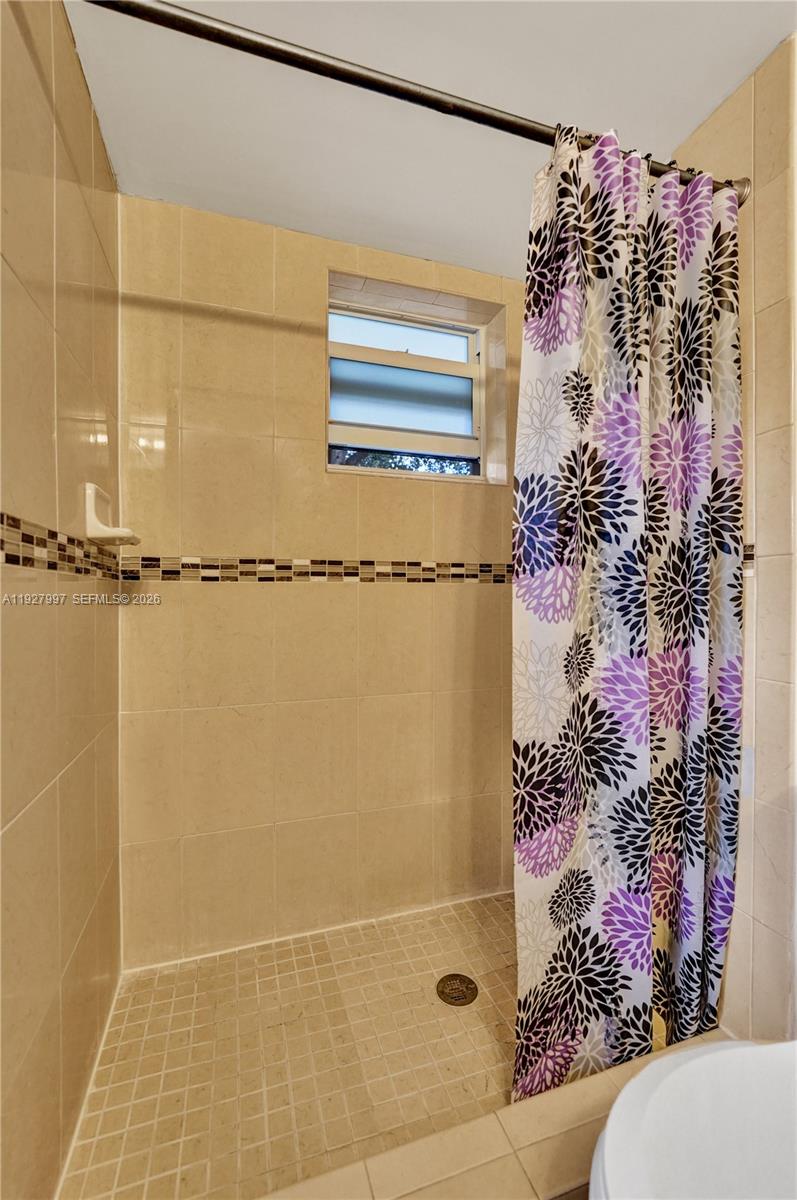 7610 Stirling Road, Unit 207C Davie, FL 33024 - Photo 13 of 16 a bathroom with a shower curtain and a window