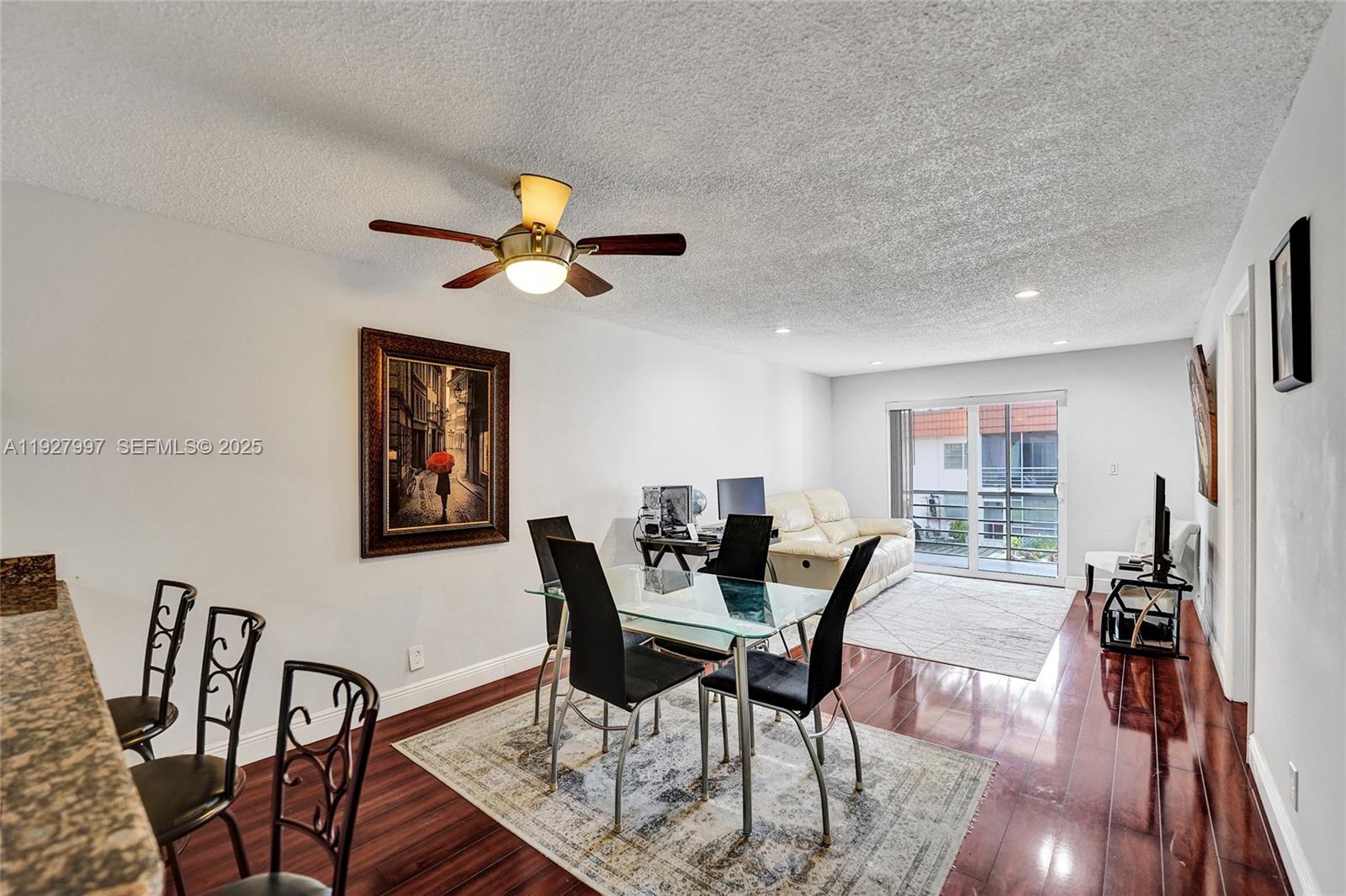 7610 Stirling Road, Unit 207C Davie, FL 33024 - Photo 2 of 16 a dining room with furniture a chandelier and wooden floor