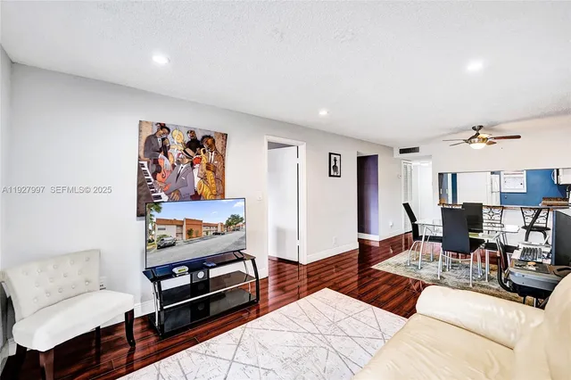 a living room with furniture and wooden floor