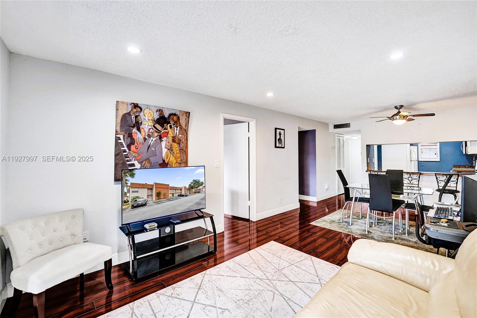7610 Stirling Road, Unit 207C Davie, FL 33024 - Photo 3 of 16 a living room with furniture and wooden floor