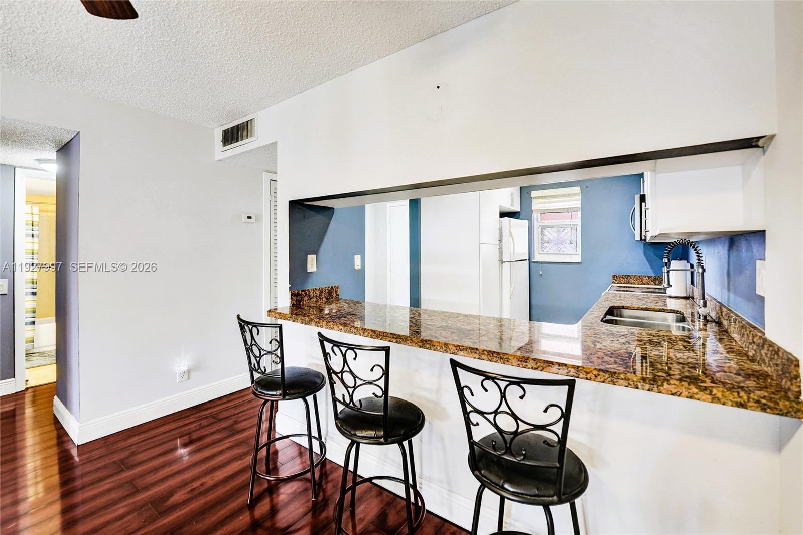 7610 Stirling Road, Unit 207C Davie, FL 33024 - Photo 4 of 16 a view of a dining room with furniture and wooden floor