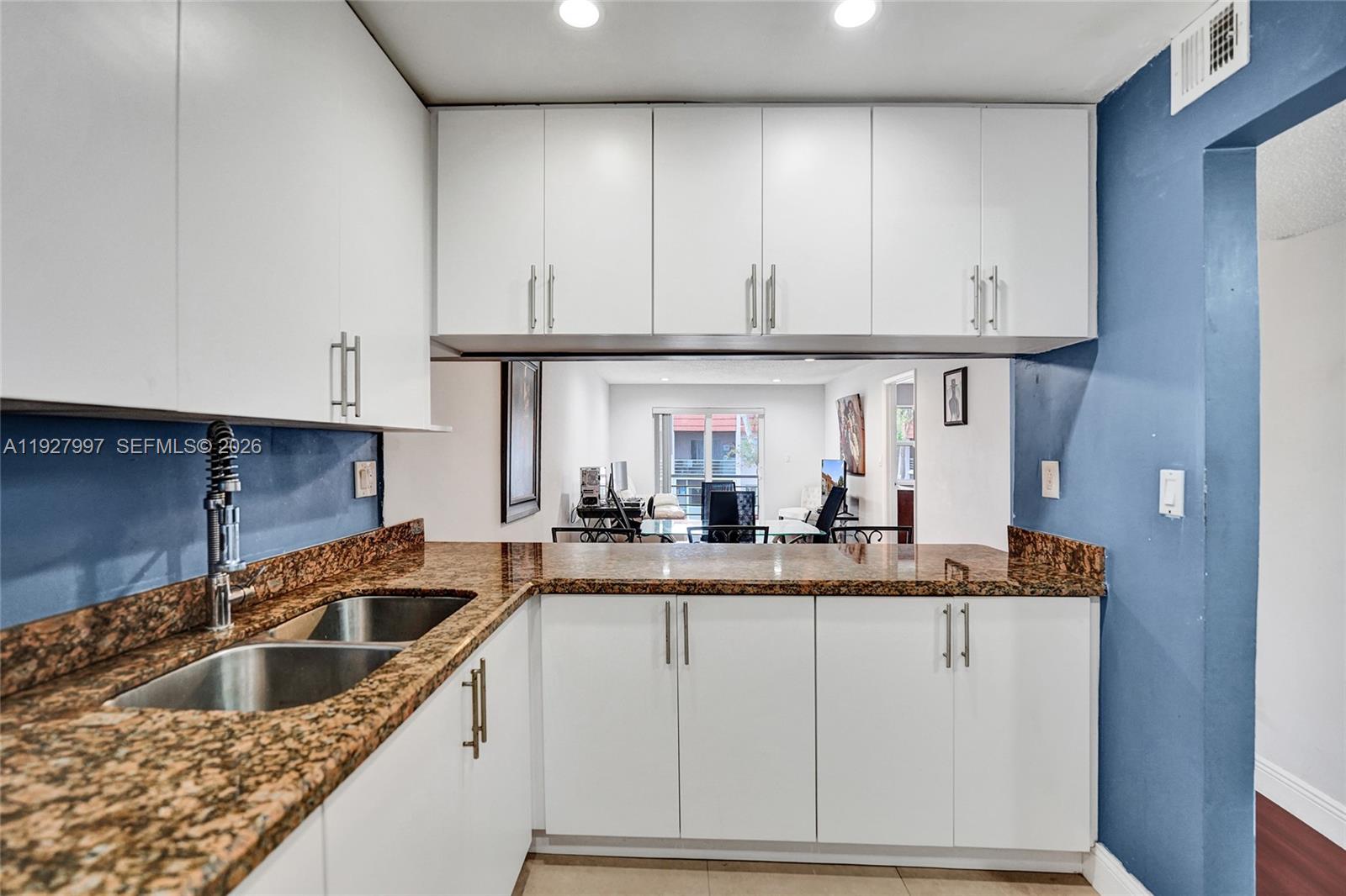 7610 Stirling Road, Unit 207C Davie, FL 33024 - Photo 7 of 16 a kitchen with granite countertop a sink and cabinets