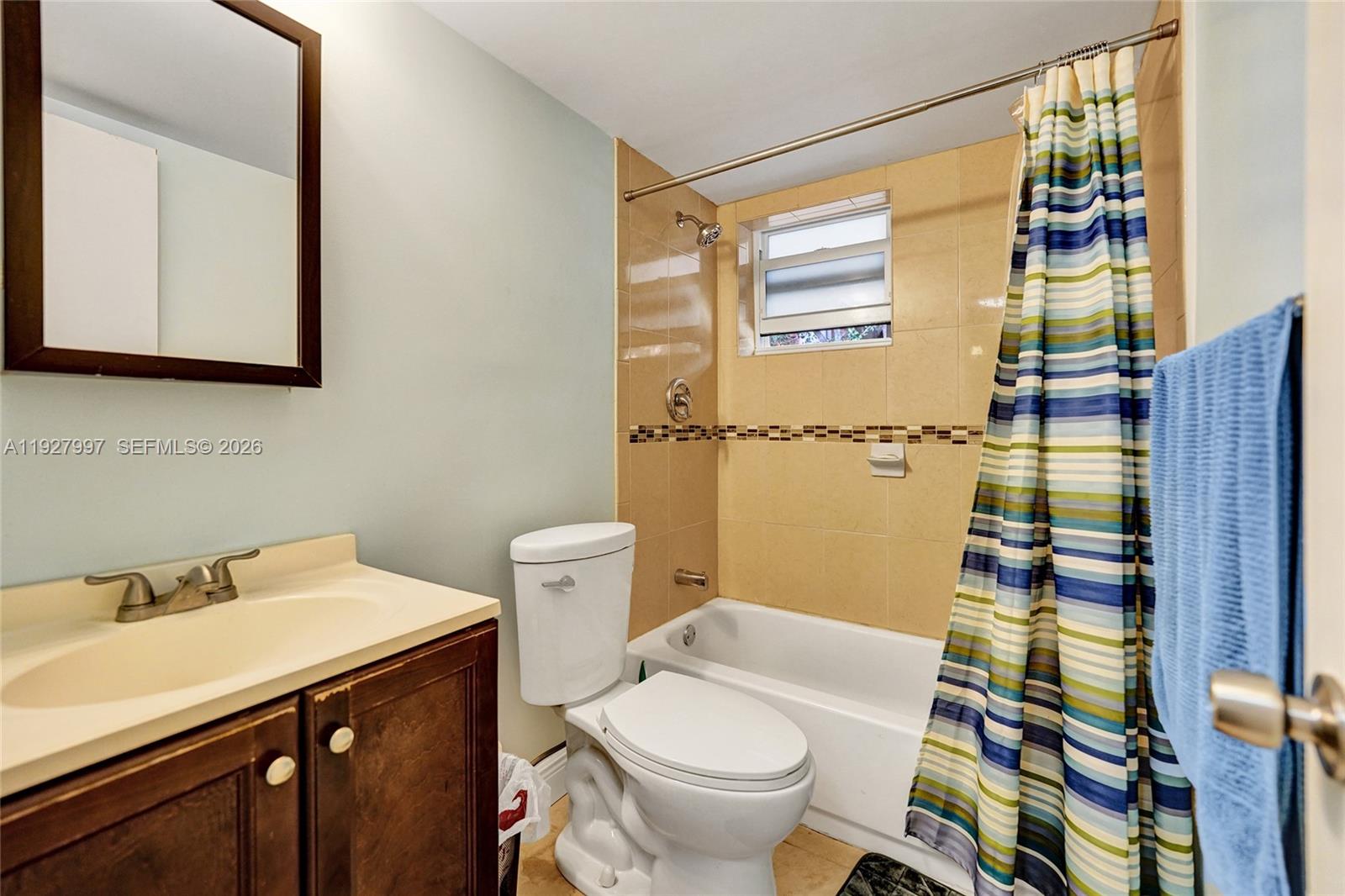 7610 Stirling Road, Unit 207C Davie, FL 33024 - Photo 9 of 16 a bathroom with a sink a toilet and shower