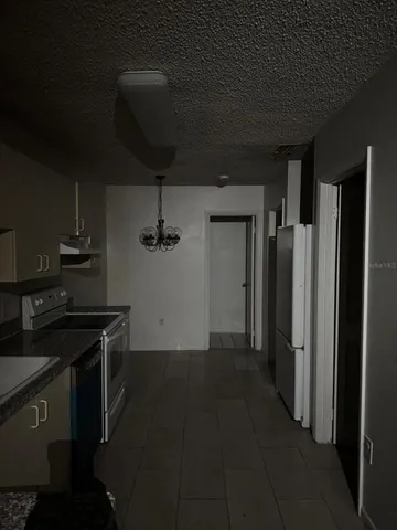 a kitchen with a stove and a refrigerator