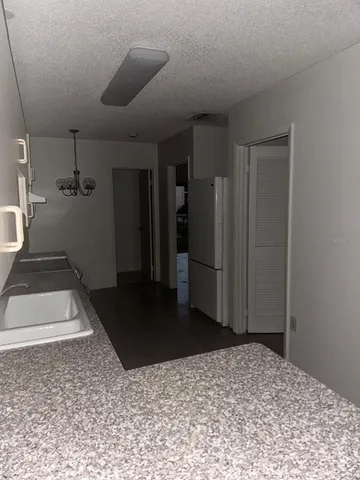 a view of a hallway with a refrigerator