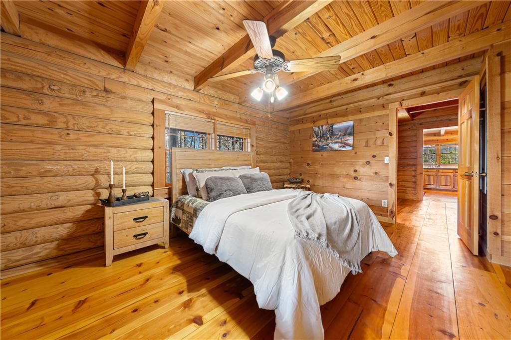 451 Pinecrest Road Sautee Nacoochee, GA 30571 - Photo 19 of 45 a spacious bedroom with a bed and wooden floor