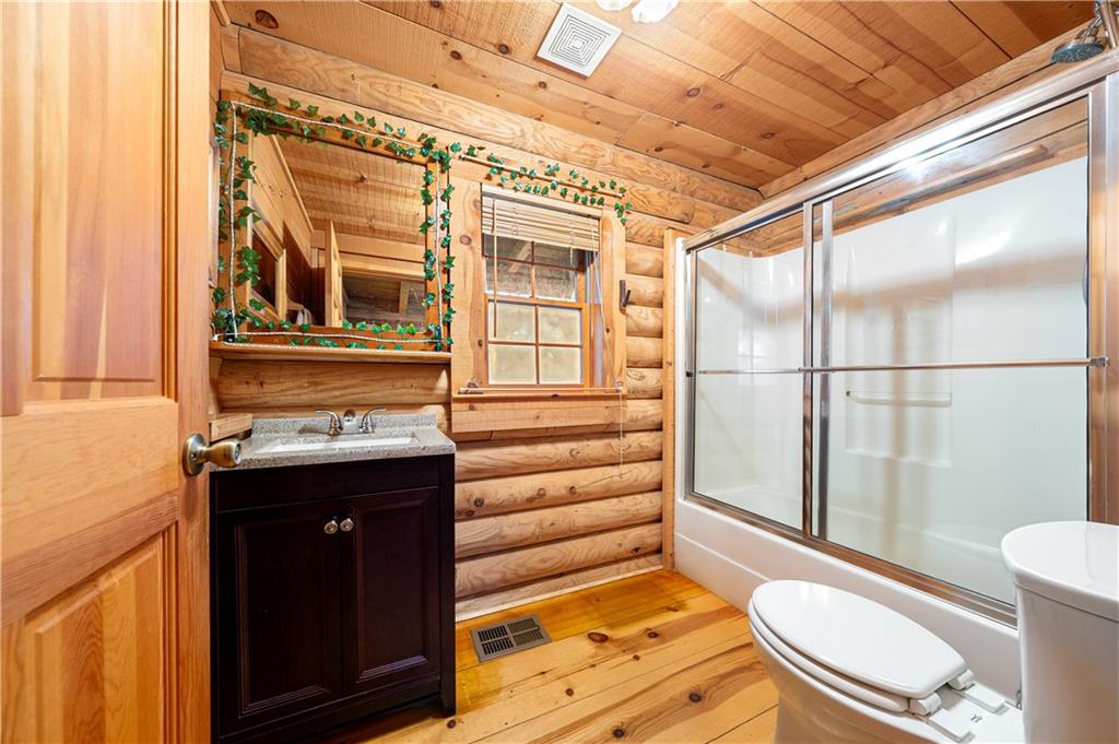 451 Pinecrest Road Sautee Nacoochee, GA 30571 - Photo 20 of 45 a bathroom with a sink a toilet a mirror and shower