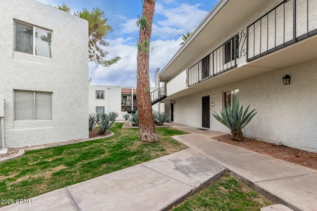 a view of a house with a small yard and a large window