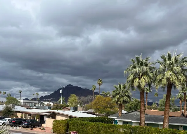 a view of a street with a cars parked on the road