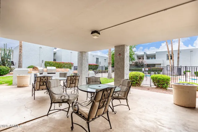 a view of a house with swimming pool and sitting area