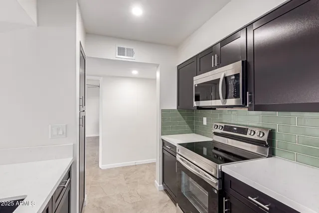 a kitchen with a stove and a microwave