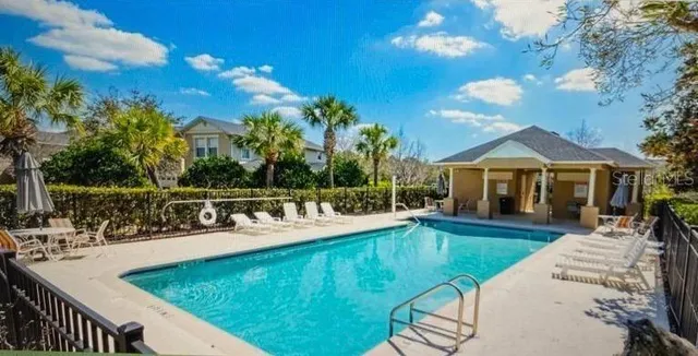 a view of a house with swimming pool and sitting area