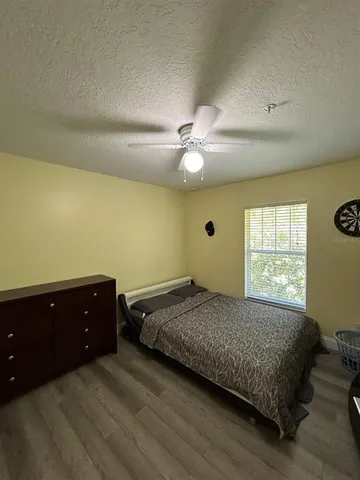 a bedroom with a bed and window