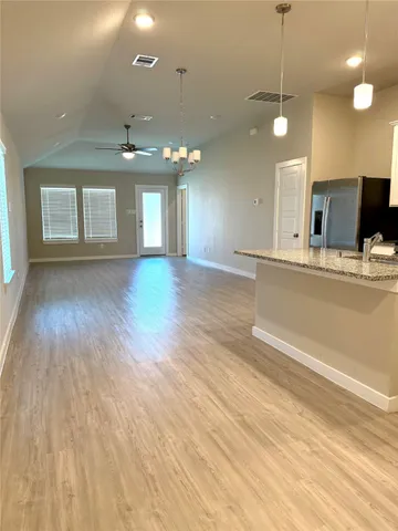 a bathroom with a double vanity sink a toilet and shower