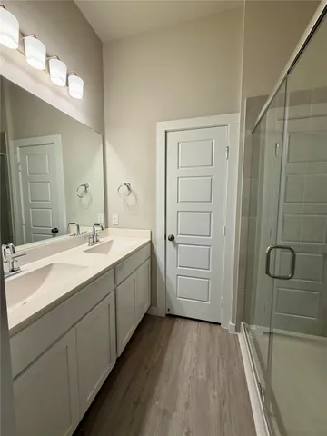 a white kitchen with a sink and a refrigerator