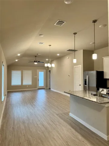 a view of a kitchen with a sink and a wooden floor