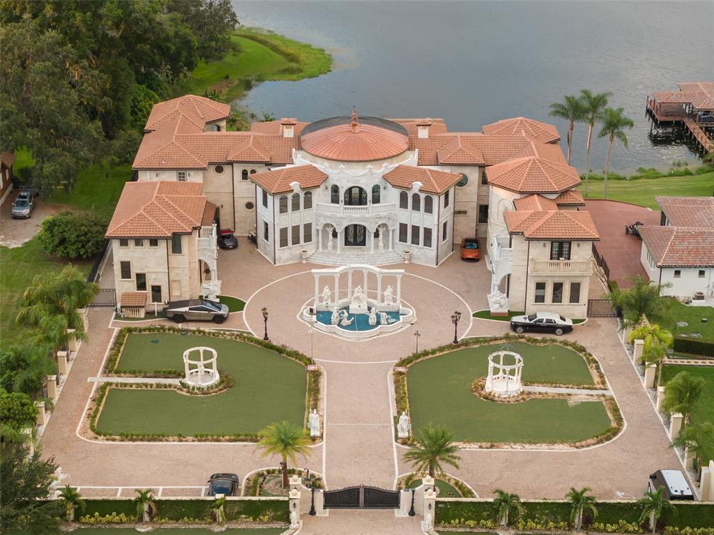 an aerial view of a house with swimming pool and outdoor seating