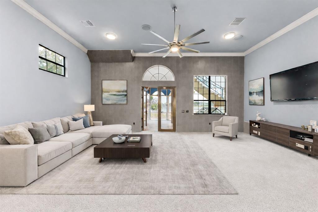 9639 Westover Roberts Road Windermere, FL 34786 - Photo 20 of 78 a living room with furniture a flat screen tv and a window