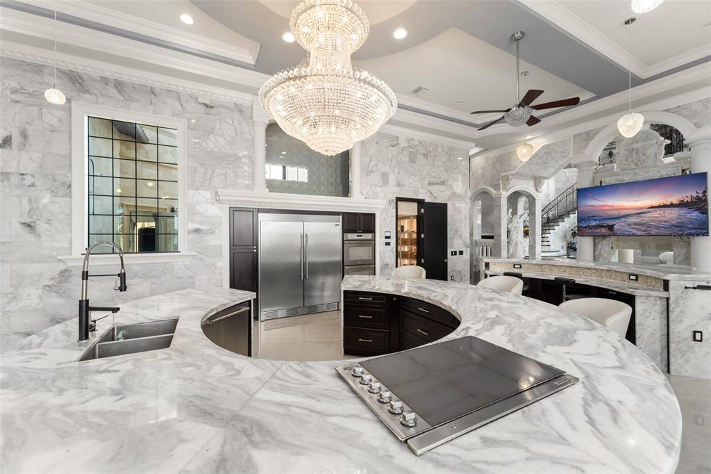 9639 Westover Roberts Road Windermere, FL 34786 - Photo 26 of 65 a kitchen with stainless steel appliances kitchen island granite countertop a sink table and chairs