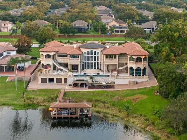 an aerial view of a house with a garden and swimming pool