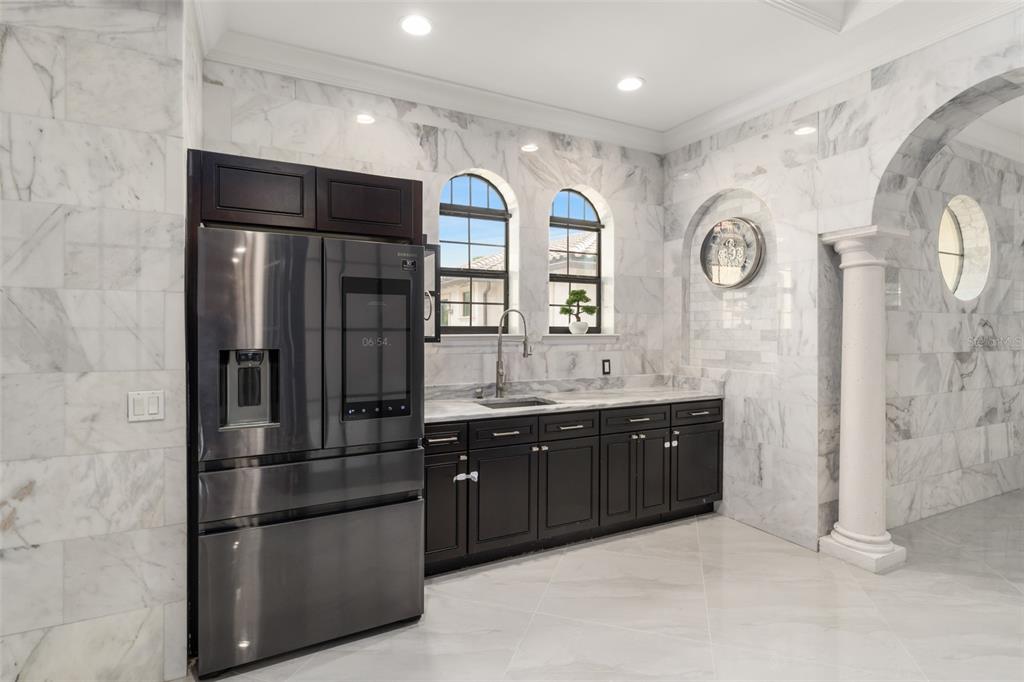 9639 Westover Roberts Road Windermere, FL 34786 - Photo 59 of 65 a kitchen with stainless steel appliances granite countertop a refrigerator and a sink
