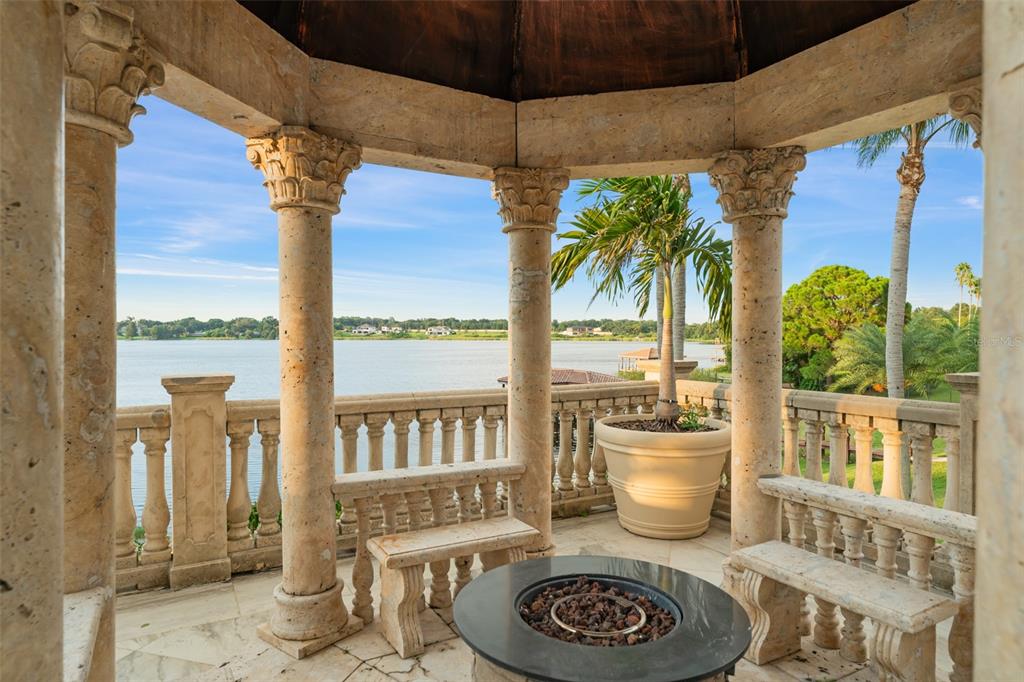 9639 Westover Roberts Road Windermere, FL 34786 - Photo 64 of 65 a dining room with furniture water view and a floor to ceiling window