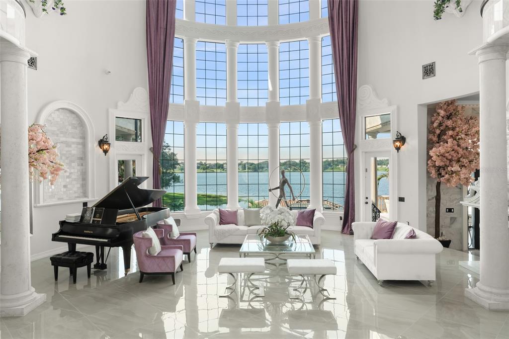 9639 Westover Roberts Road Windermere, FL 34786 - Photo 8 of 65 a living room with furniture and floor to ceiling windows