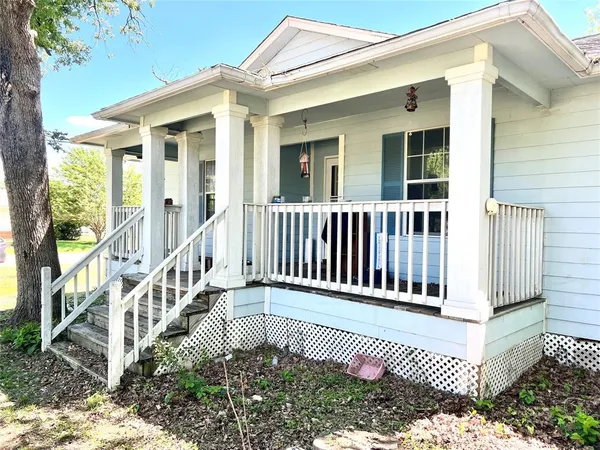 a view of a house with wooden fence