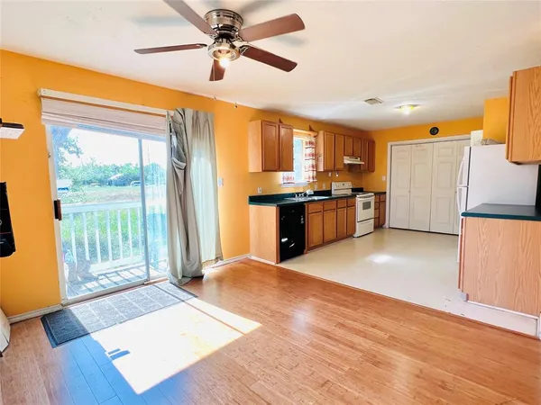 a view of a kitchen with a stove cabinets and wooden floor