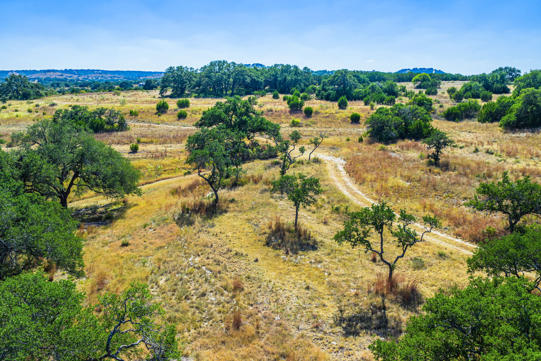 1495 Walnut Springs Road Johnson City, TX 78636 - Photo 6 of 23 a view of a lake with beach and city view