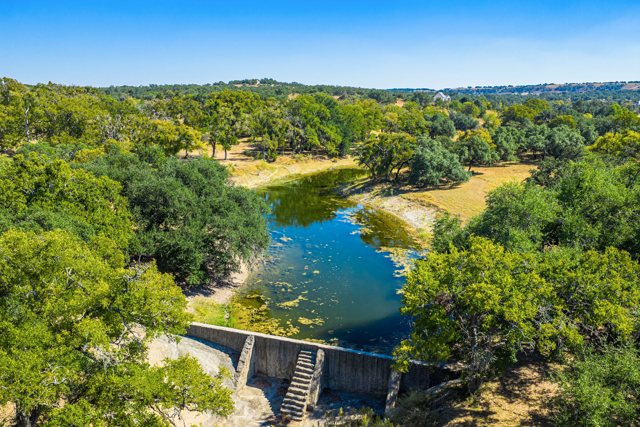 1495 Walnut Springs Road Johnson City, TX 78636 - Photo 9 of 23 a view of a lake with a garden