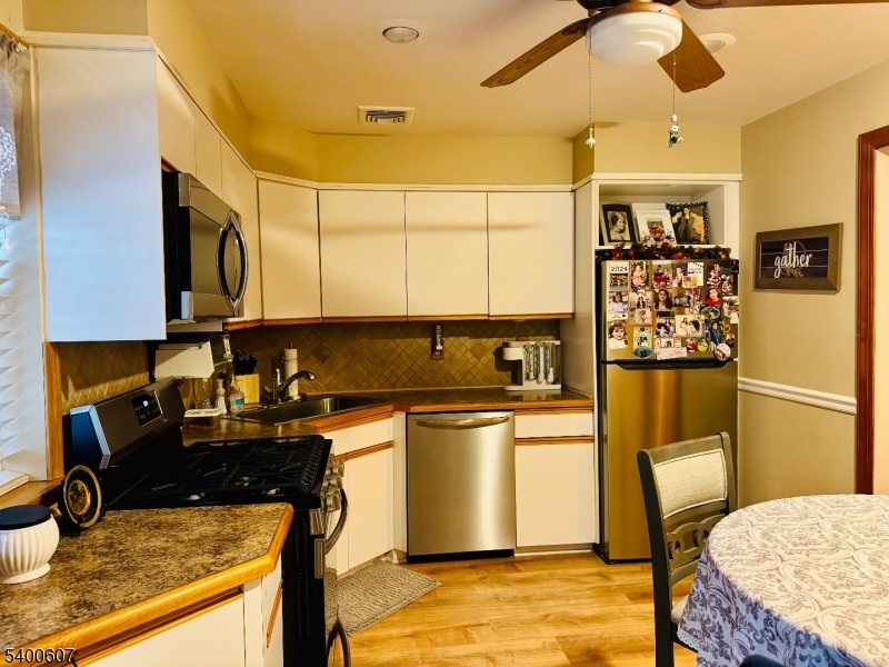 559 South Springfield Avenue Springfield, NJ 07081 - Photo 11 of 20 a kitchen with stainless steel appliances granite countertop a sink stove and refrigerator