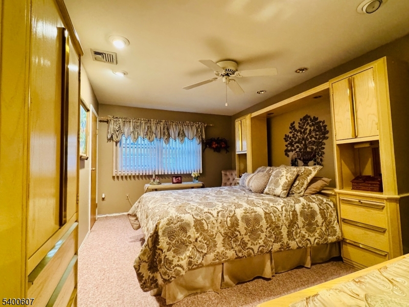559 South Springfield Avenue Springfield, NJ 07081 - Photo 15 of 20 a bedroom with a bed and wooden floor
