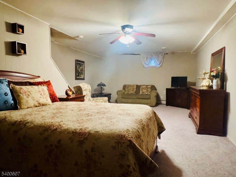 559 South Springfield Avenue Springfield, NJ 07081 - Photo 18 of 20 a spacious bedroom with a bed and furniture
