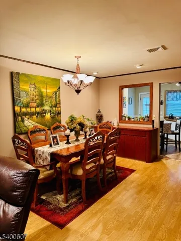 a living room with lots of chairs and chandelier