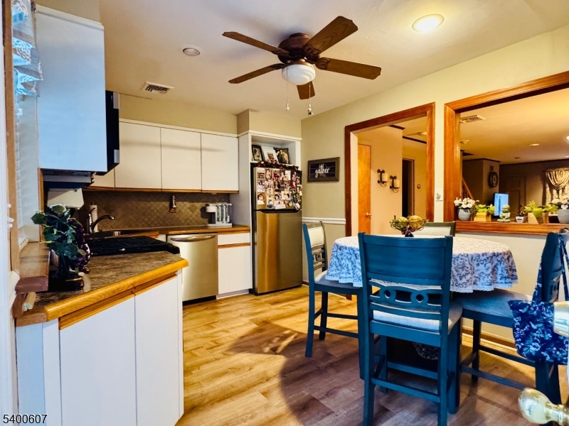 559 South Springfield Avenue Springfield, NJ 07081 - Photo 10 of 20 a kitchen that has a table chairs in it and wooden floors