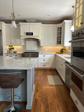 a kitchen with a sink a stove and cabinets