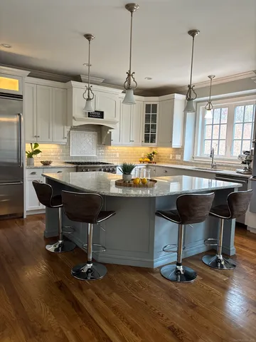 a kitchen with a counter space appliances and a chandelier