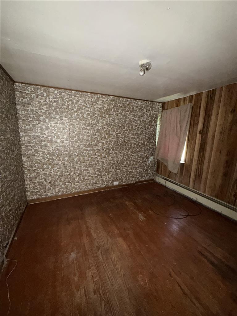 5114 Three Lakes Road New Milford, PA 18834 - Photo 27 of 55 Classic wood flooring and patterned wall finishes define this interior room.