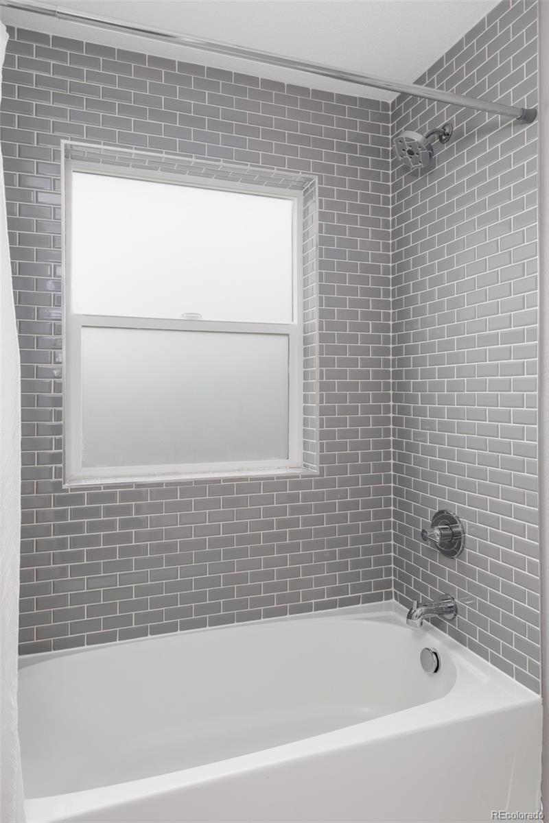 5230 Stuart Street Denver, CO 80212 - Photo 24 of 34 a bathroom with a bathtub